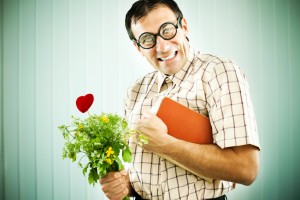 Man holding flowers and a notebook.